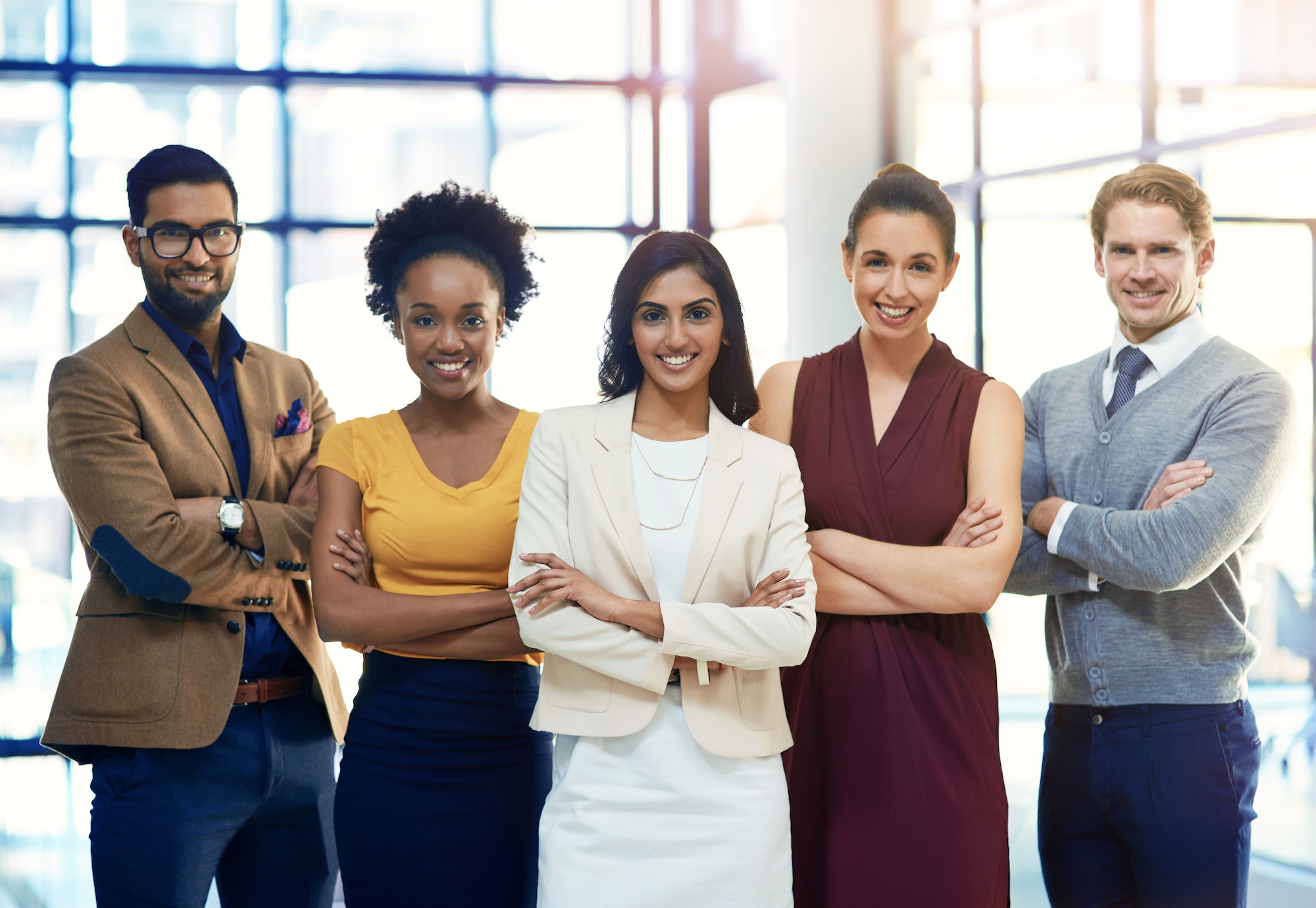 Portrait of a diverse group of businesspeople standing together in an office